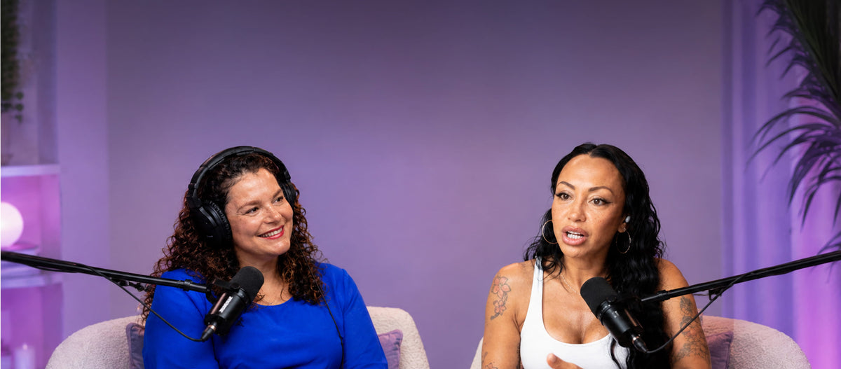 Set against a violet studio backdrop, two creators exchange perspectives in a relaxed podcast conversation.